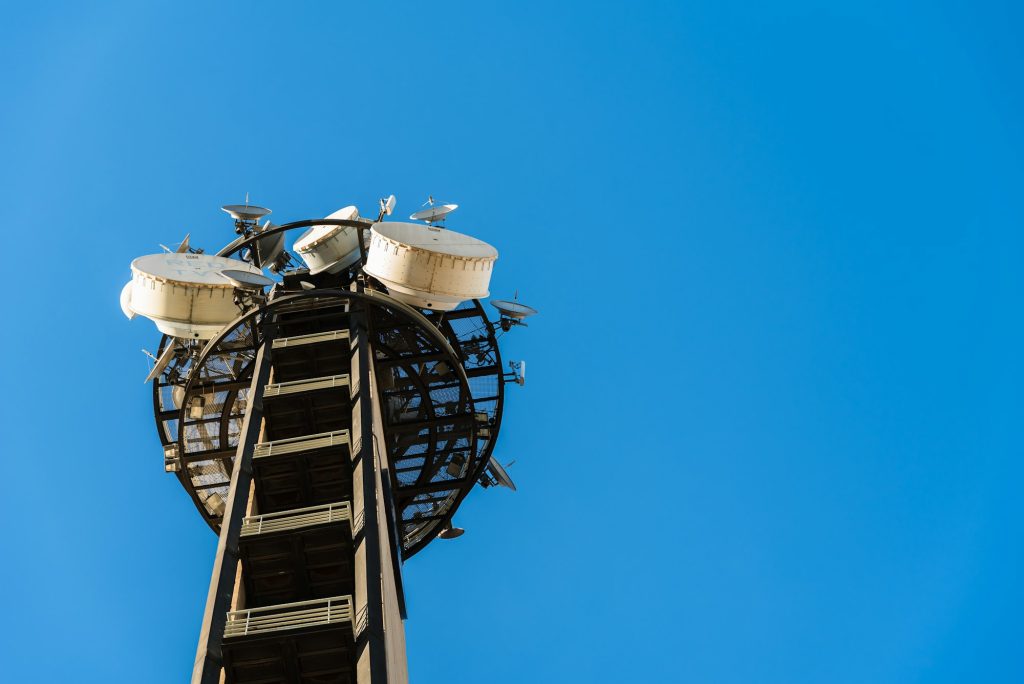 Large telecommunications tower full of radio and television broadcast antennas.